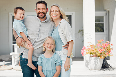Buy stock photo Portrait of happy parents standing with their children in front of their new property. Smiling caucasian couple bonding with their adorable son and daughter in front of their new home