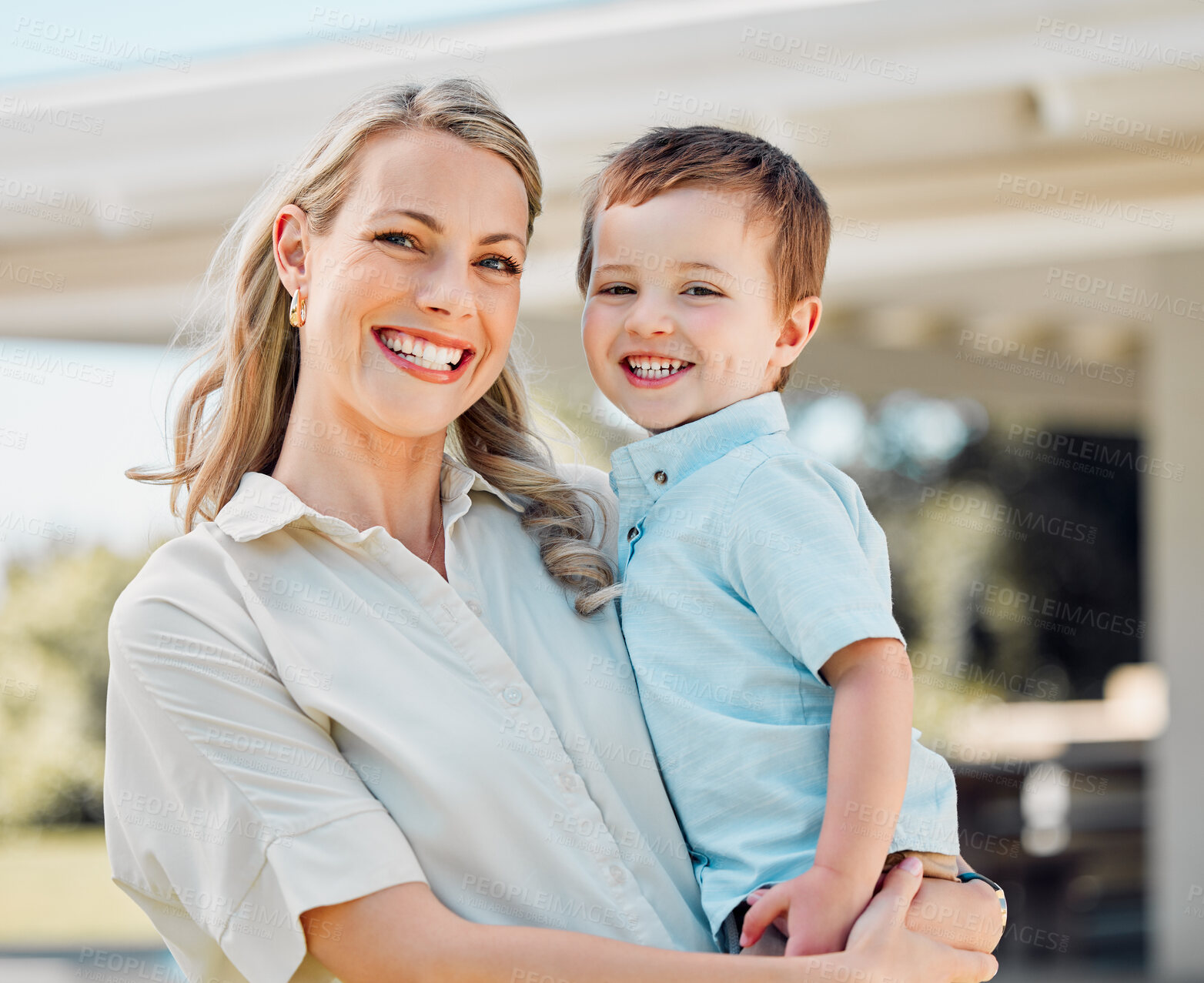 Buy stock photo Portrait of happy caucasian mother holding cheerful son while having fun in the sun outside. Smiling woman carrying carefree boy while bonding in the yard. Loving mom enjoying quality time with kid