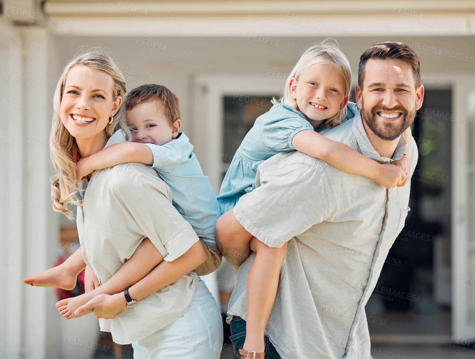 Buy stock photo Portrait of happy parents giving their little children piggyback rides outside in a garden. Smiling caucasian couple bonding with their adorable son and daughter in the backyard. Playful kids enjoying