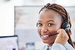 Portrait of happy smiling african american call centre telemarketing agent talking on headset in office. Face of confident friendly businesswoman operating helpdesk for customer service sales support