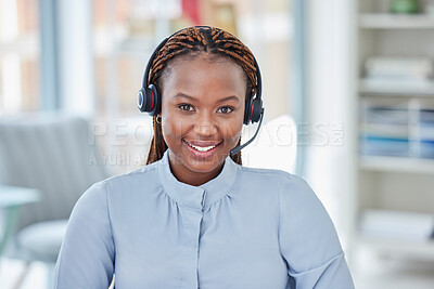 Portrait of smiling african american business woman wearing headset with microphone. Customer service rep looking positive while sitting in office answering calls