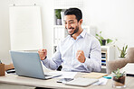 Young happy and cheerful mixed race businessman cheering with his fists while working on a laptop alone in an office at work. One confident hispanic male boss smiling while celebrating a victory 