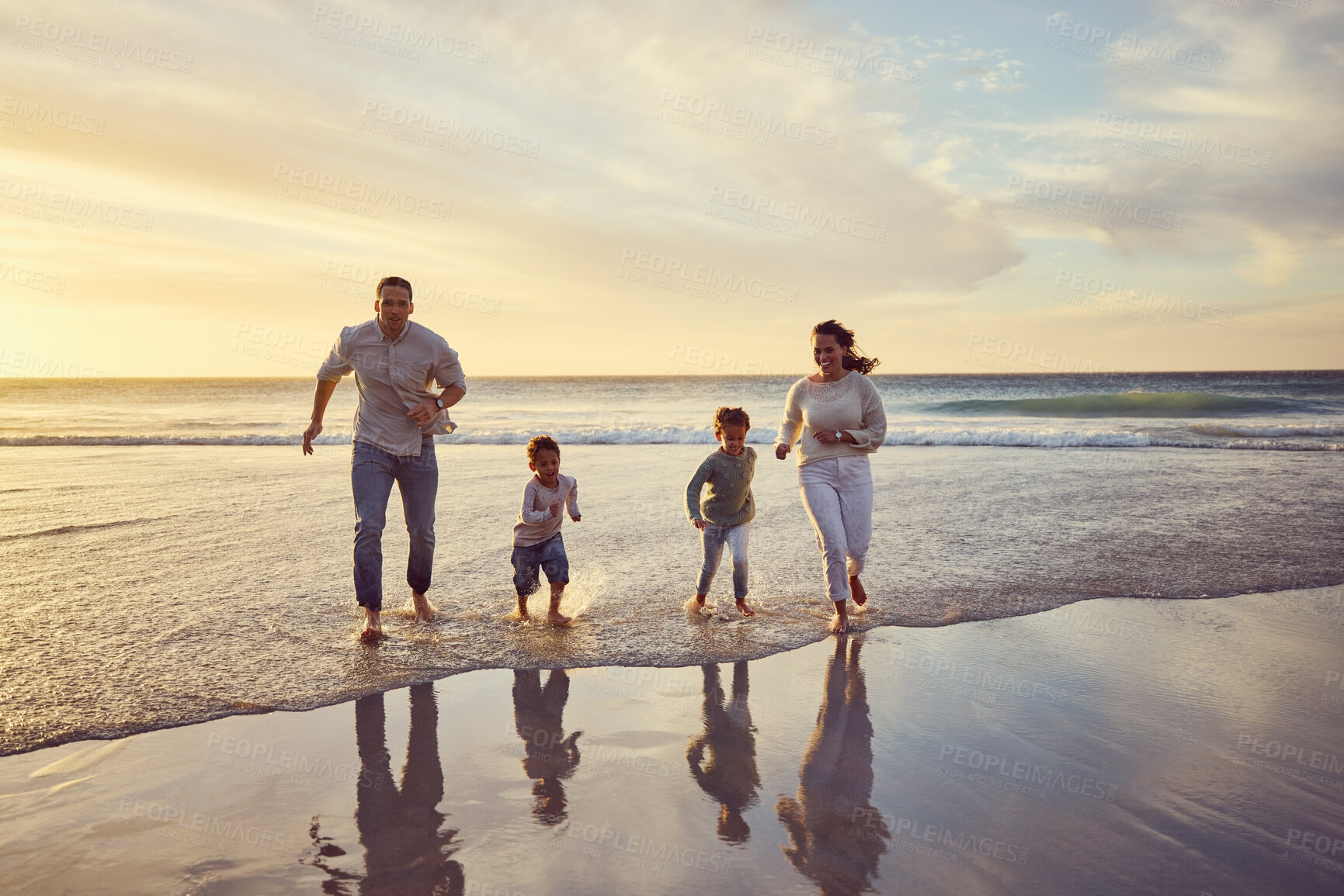 Buy stock photo Beach, sunset and parents play with kids on holiday, summer vacation and weekend together. Nature, family and happy mother, father and children run in ocean for bonding, adventure and quality time