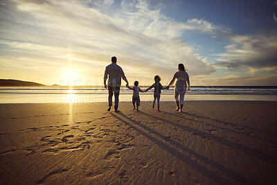 Buy stock photo Sunrise, beach and back of family holding hands and walking on holiday, summer vacation and weekend. Nature, travel and mother, father and children by ocean for bonding, adventure and quality time