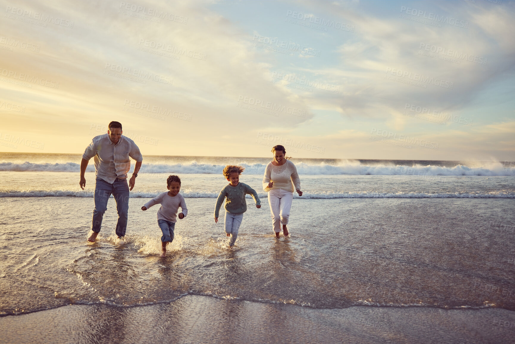 Buy stock photo Beach, sunset and parents run with children on holiday, summer vacation and weekend together. Nature, travel and happy mother, father and kids play in ocean for bonding, adventure and family time