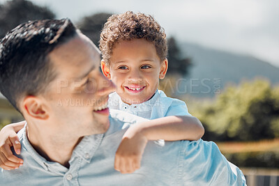 Buy stock photo Father carrying boy on back while spending time together outdoors on a sunny day. Adorable mixed race kid having fun playing with dad and getting a piggyback ride