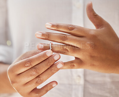 Buy stock photo Close up of woman taking off wedding ring. Hands removing or putting on ring. Wife making hard decision to leave husband in unhappy marriage