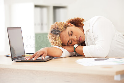 Young mixed race business woman sleeping in a office in front of a laptop on the desk. Latin female entrepreneur asleep with her eyes closed while working on her small business from home