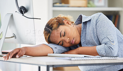 One exhausted african american call centre agent sleeping in an office. Businesswoman feeling overworked, tired and demotivated while operating helpdesk. Lazy consultant slacking and ignoring clients by taking a nap. Burnout and stress in workplace