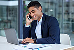 One happy mixed race businessman talking on cellphone while browsing on laptop in an office. Confident hispanic entrepreneur networking with clients on phone while busy planning deadlines and tasks