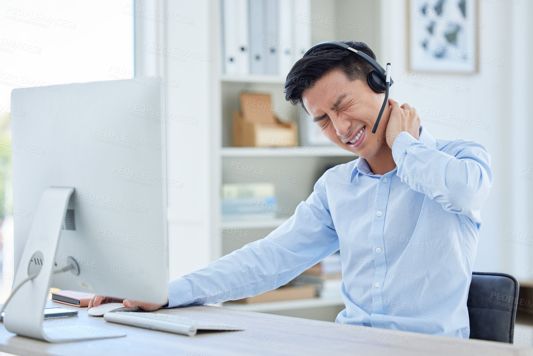 Buy stock photo Call center, neck pain and man consulting for customer service while suffering arthritis or inflammation in office. Spine, headache and asian male consultant with posture issue while working for crm