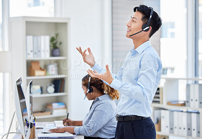 Buy stock photo Customer service, man and standing for consulting in call centre with headset, talking and hand gestures. Telemarketing, asian person or financial advisor and employee, computer or happy for helping
