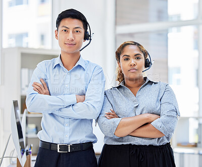 Portrait of call center colleagues. Business People working in customer service wearing headsets, arms crossed.Smiling sales reps. IT service agents at work in the office. Two diverse coworkers