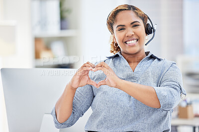 Portrait of mixed race call center agent showing heart shape with hands. Confident and smiling businesswoman consulting and operating a helpdesk for customer sales and service support