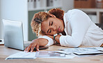 Young mixed race businesswoman sleeping at her desk in an office alone at work. Hispanic woman taking a nap while working with a laptop. Female boss taking a break and resting