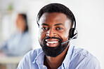 Portrait of one happy smiling african american call centre telemarketing agent talking on headset in office. Face of confident and friendly businessman operating helpdesk for customer service and sales support