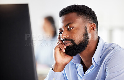 One exhausted african american businessman looking bored while working on computer in an office. Guy feeling overworked, tired and demotivated. Lazy employee slacking and ignoring deadlines. Burnout and stress in workplace