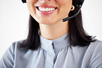 Closeup of one happy caucasian call centre telemarketing agent with big smile talking on headset while working in office. Face of confident friendly businesswoman operating helpdesk for customer service and sales support