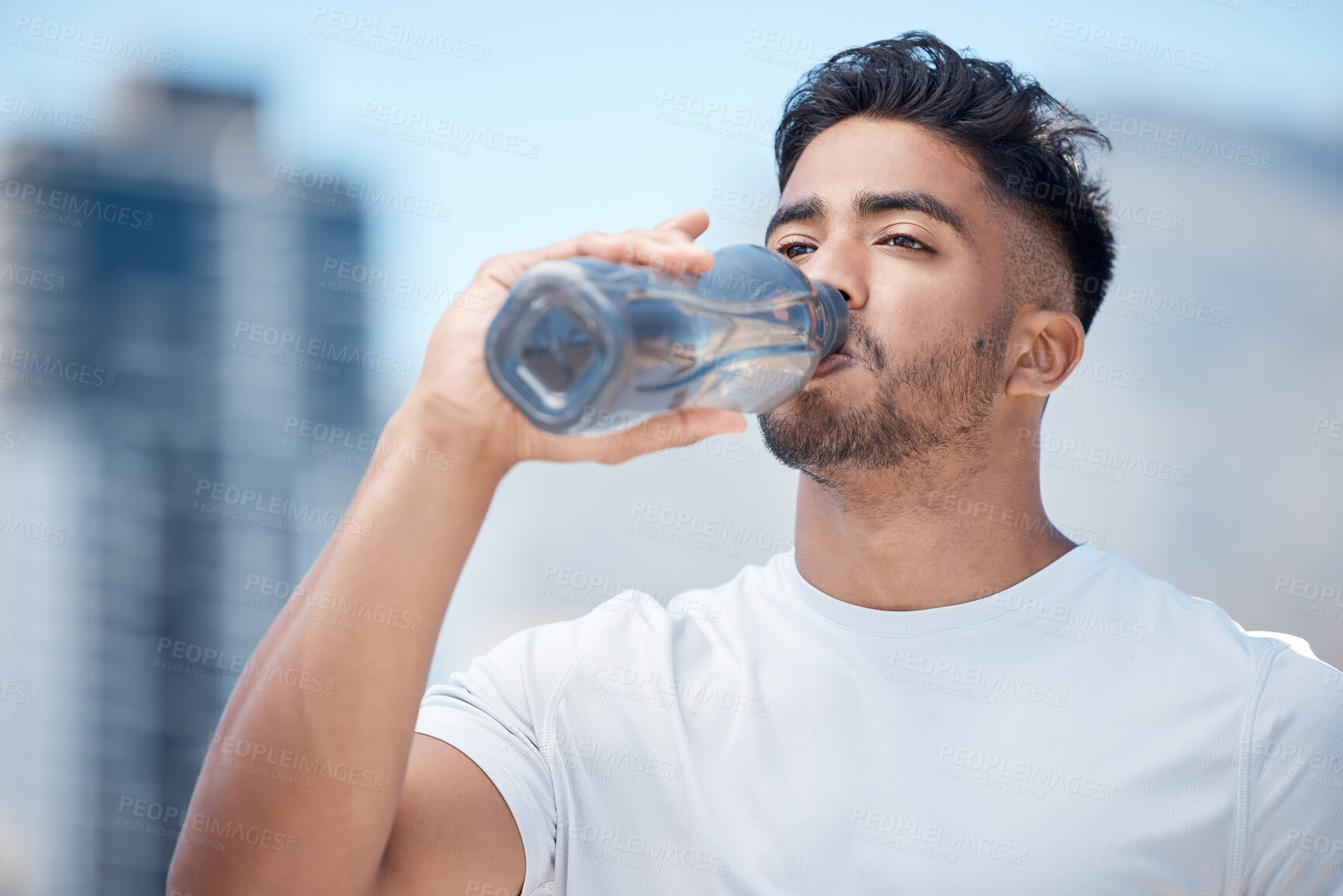 Buy stock photo Man, fitness and drinking water in city workout, cardio exercise or running for sustainability outdoors. Thirsty male person, athlete or runner with drink for hydration, rest or break in urban town