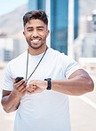 Portrait of satisfied mixed race male athlete checking digital chronometer and smart watch to track time during a workout. Sportsman monitoring his performance or progress during a run in the city