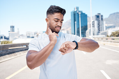 Buy stock photo Fitness, man and watch in city for pulse, heart rate or checking performance after workout or exercise. Fit, active and sporty male person, athlete or runner looking at wristwatch for cardio health