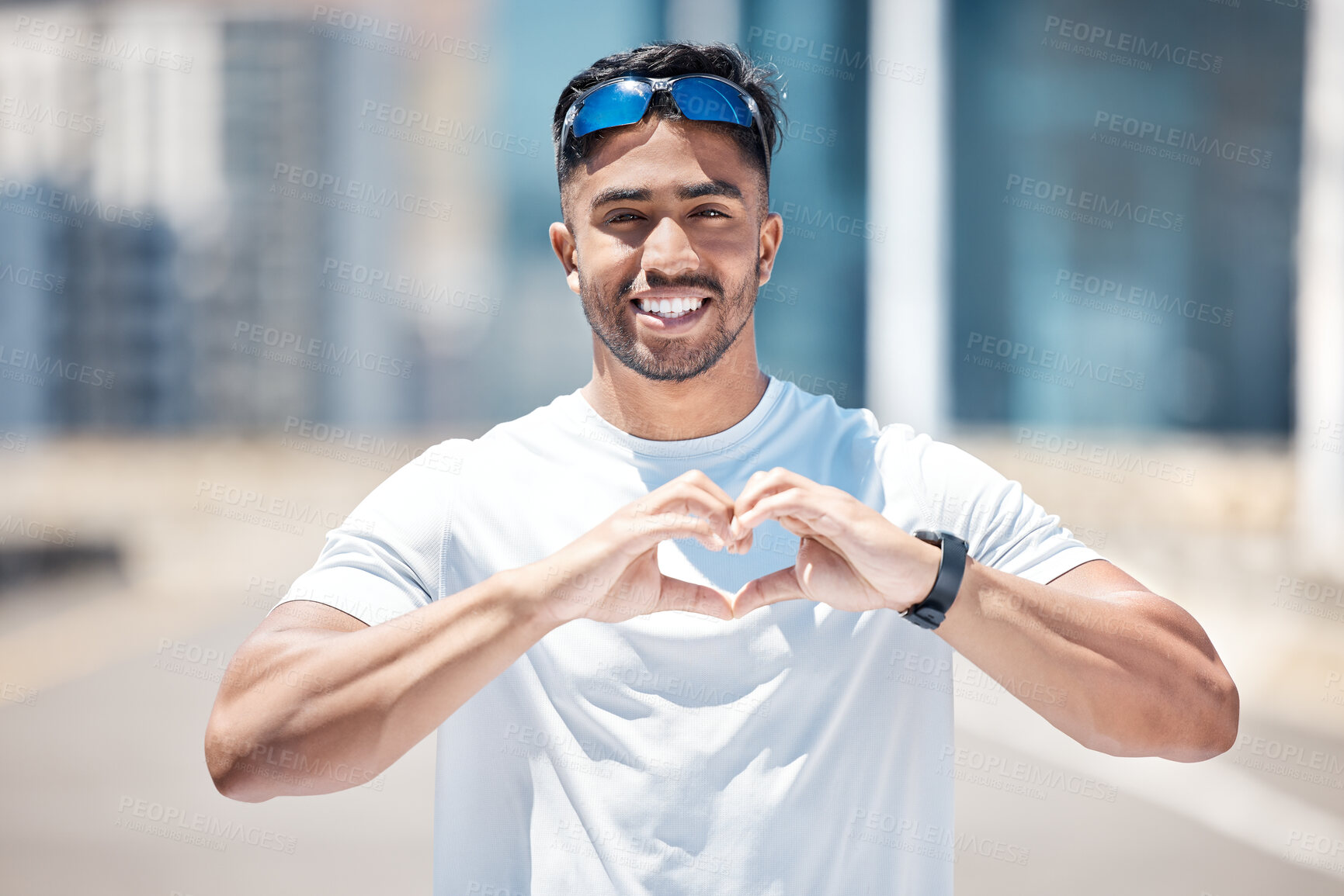 Buy stock photo Happy man in portrait, heart hands and athlete outdoor, sports and fitness with health and wellness. Healthy male person smile in city, self love and care with cardio, exercise with emoji or sign