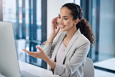 Portrait of happy smiling mixed race call centre telemarketing agent talking on headset in office. Face of confident friendly businesswoman operating helpdesk for customer service sales support in front of a laptop