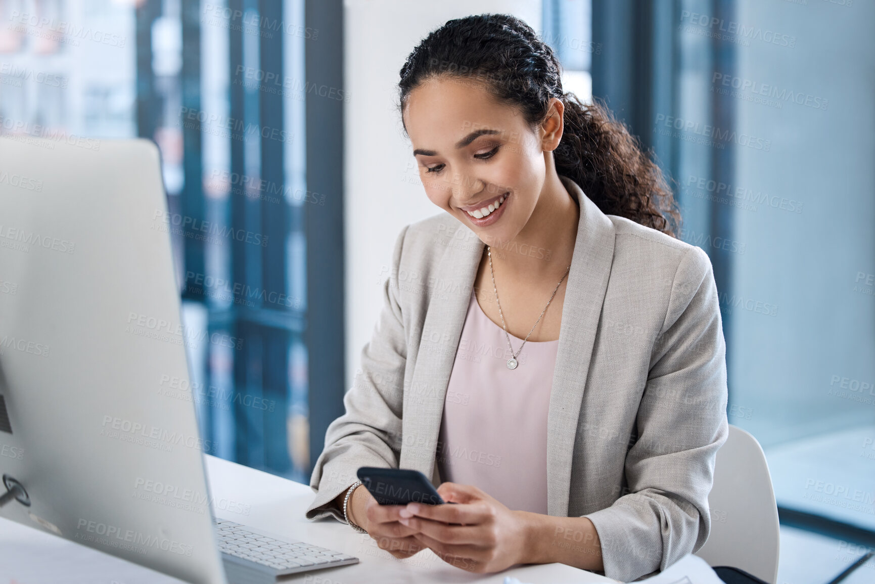 Buy stock photo Young business woman, texting and phone in office with smile, email communication and chat with online date. Businesswoman, smartphone and typing for contact, networking and social media app at desk