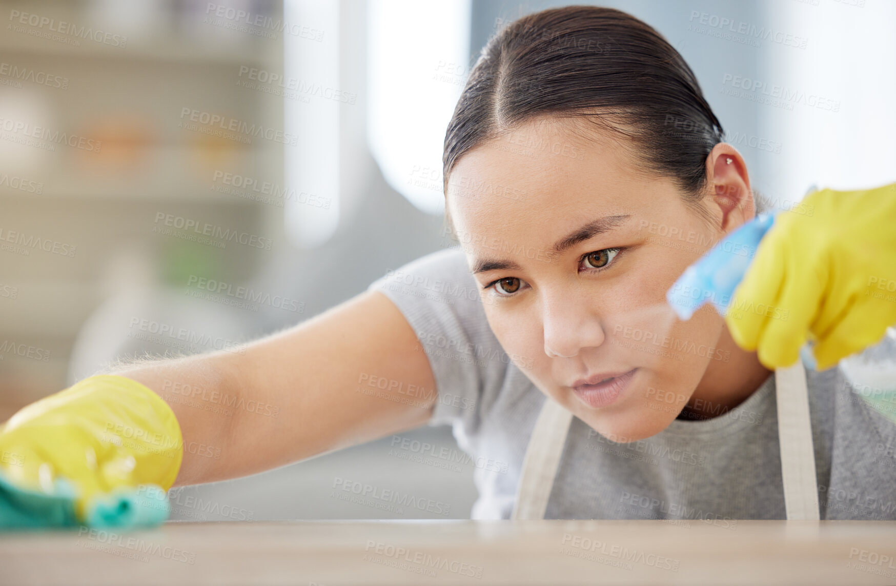 Buy stock photo Spray, table and cleaning with a woman housekeeper using disinfectant to remove bacteria in a home. Safety, surface and hygiene with a young female cleaner working in a house living room for service