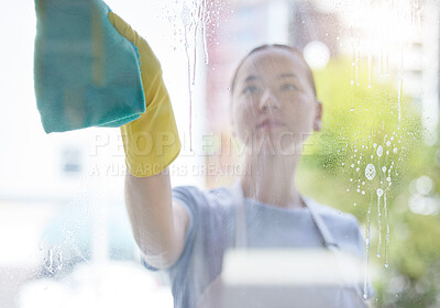 Buy stock photo Wipe, window and cleaning with a woman housekeeper using disinfectant to remove bacteria in a home. Safety, glass and hygiene with a young female cleaner working in a domestic house for service