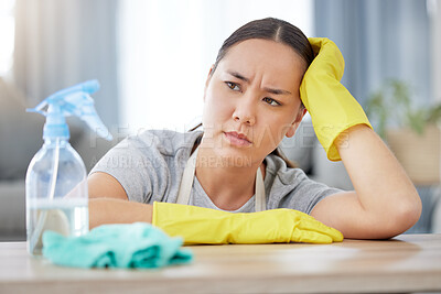 Buy stock photo Thinking, annoyed and cleaning with a woman housekeeper using disinfectant to remove bacteria in a home. Idea, frustrated and hygiene with a young female cleaner working in a living room for service