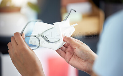 Buy stock photo Hands, vision and a person cleaning glasses in her office with a tissue for clear eyesight closeup. Wiping, prescription lenses and frame with an adult holding eyewear to clean using a wet wipe