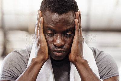 Closeup of stressed african american athlete touching face with hands after workout in gym. Strong, fit, active black man feeling anxious and exhausted while taking break. Tired after routine exercise