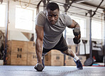 Fullbody young african american athlete lifting dumbbell during tricep curl workout in gym. Strong, fit, active black man training with weights in health and sport club. Weightlifting exercise routine