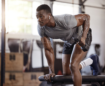 Buy stock photo Dumbbells, bench and exercise with a black man at gym for fitness, training workout and strong muscle. African bodybuilder person with weights for power, focus or performance with earphones for music