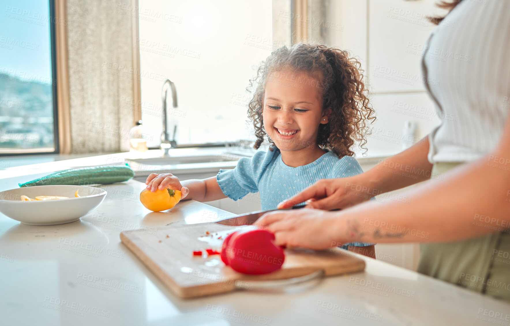 Buy stock photo Mother and daughter cooking together. Little girl preparing food with her mother. Happy child helping her parent cook. Mother and daughter preparing a tasty meal.