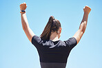 Rear view of a unknown fit and active woman celebrating a successful workout in the outdoors