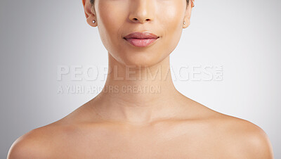 Buy stock photo Closeup of a beautiful mixed race woman's perfect neck and collar bone to model jewellery. A hispanic woman's flawless pout wearing pink lipgloss against grey studio copyspace background