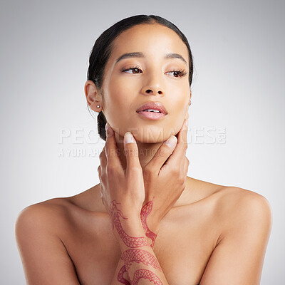 Buy stock photo A beautiful young mixed race woman with glowing skin posing against grey copyspace background. Young confident woman doing a routine selfcare grooming routine with glowing radiant skin