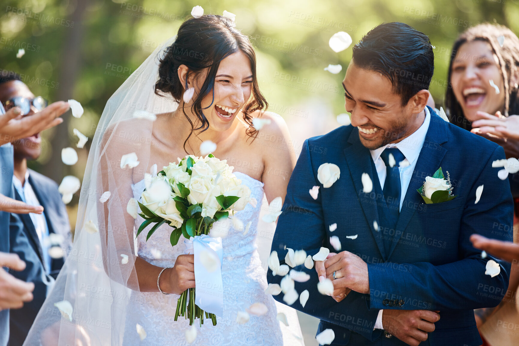 Buy stock photo Love, wedding and couple walking with petals and guests throwing in celebration of romance. Happy, smile and young bride with bouquet and groom with crowd celebrating at the outdoor marriage ceremony