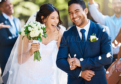 Buy stock photo Love, laughing and couple walking at their wedding with guests in celebration of romance. Happy, smile and young bride with bouquet and groom with crowd celebrating at the outdoor marriage ceremony.