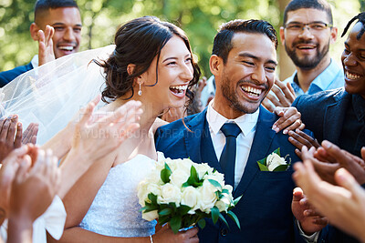 Buy stock photo Joyful bride and groom standing together while greeting guests after their wedding ceremony. Newlyweds looking happy while friends and family congratulate them on their marriage