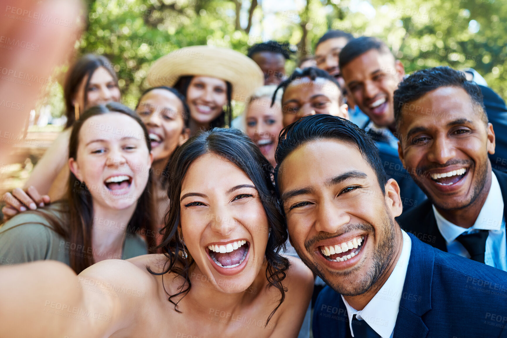 Buy stock photo Happy young newlywed couple taking selfie with friends and family. Cheerful bride and groom capturing self portrait with wedding guests outside