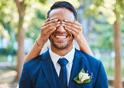 Buy stock photo Playful bride covering grooms eyes with her hands from behind and surprising him. Close up of groom smiling while waiting to see his bride