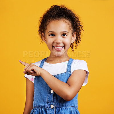 Buy stock photo Portrait, smile and girl pointing to space, direction and choice against a studio background. Face, female child and young person with gesture for decision, branding development and product placement