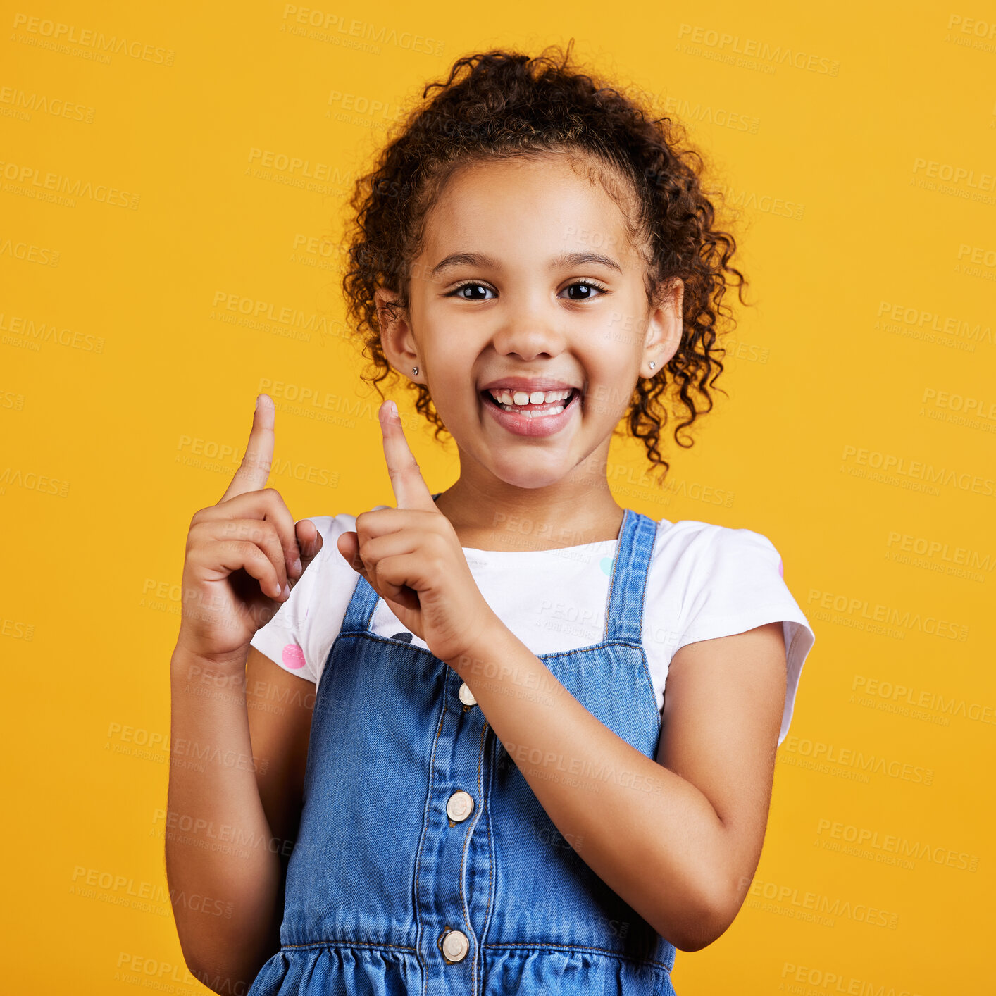 Buy stock photo Portrait, pointing up and girl with smile, branding development and happiness against a studio background. Face, female child and young person gesture for space, direction and showing with choice