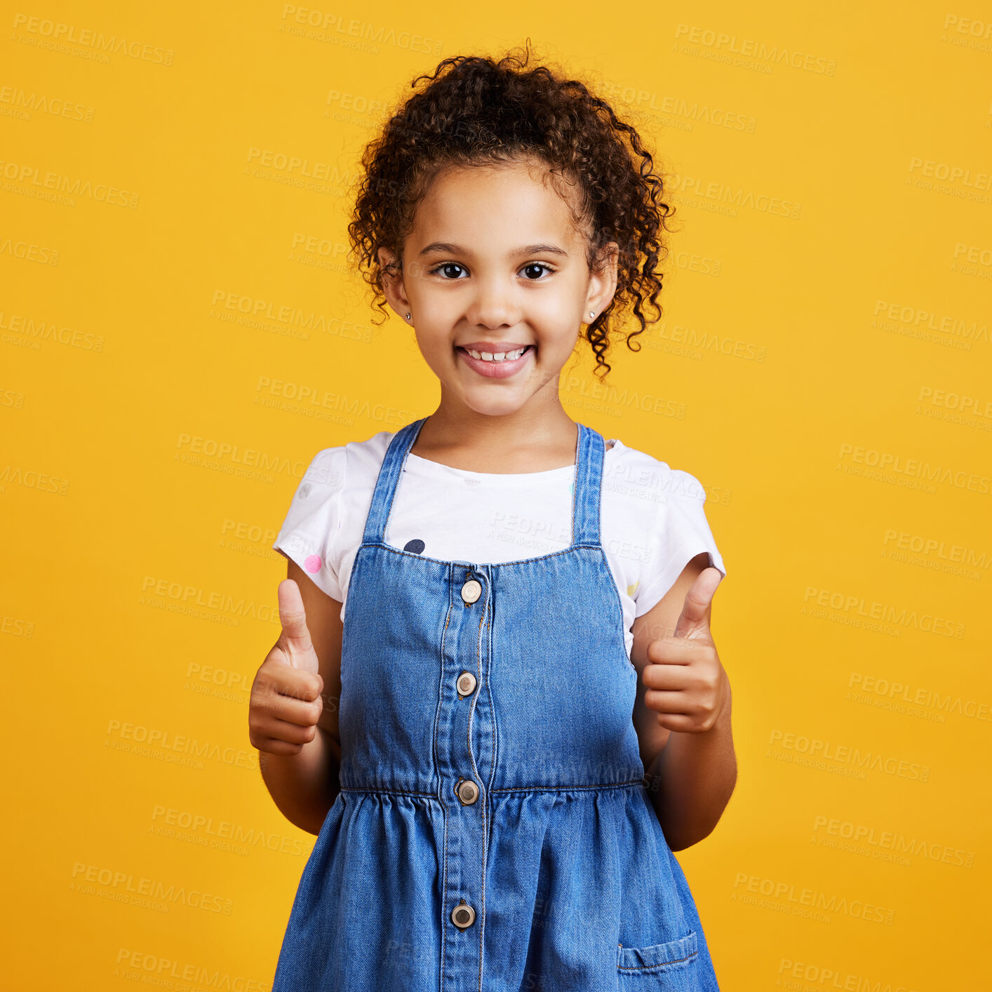 Buy stock photo Thumbs up, girl and happy portrait isolated with a orange background in studio and yes gesture. Youth, happiness and agreement kid hand sign with a smile showing positive, thank you and motivation