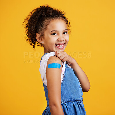Buy stock photo Portrait plaster and girl with smile, confidence and vaccination against a studio background. Face, Latino female child and happy young person showing injection, happiness and cheerful on backdrop