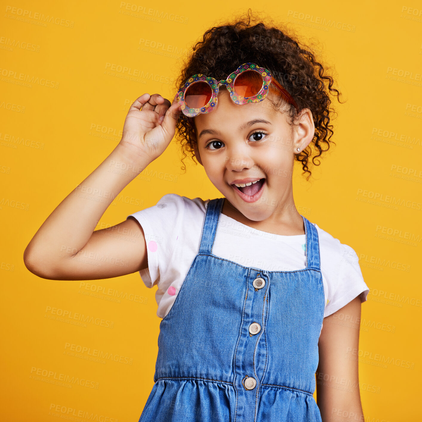 Buy stock photo Girl child, smile and sunglasses in studio portrait for summer style or happy by yellow background. Mixed race model, female kid or fashion frame on face for surprise expression, eye care and youth