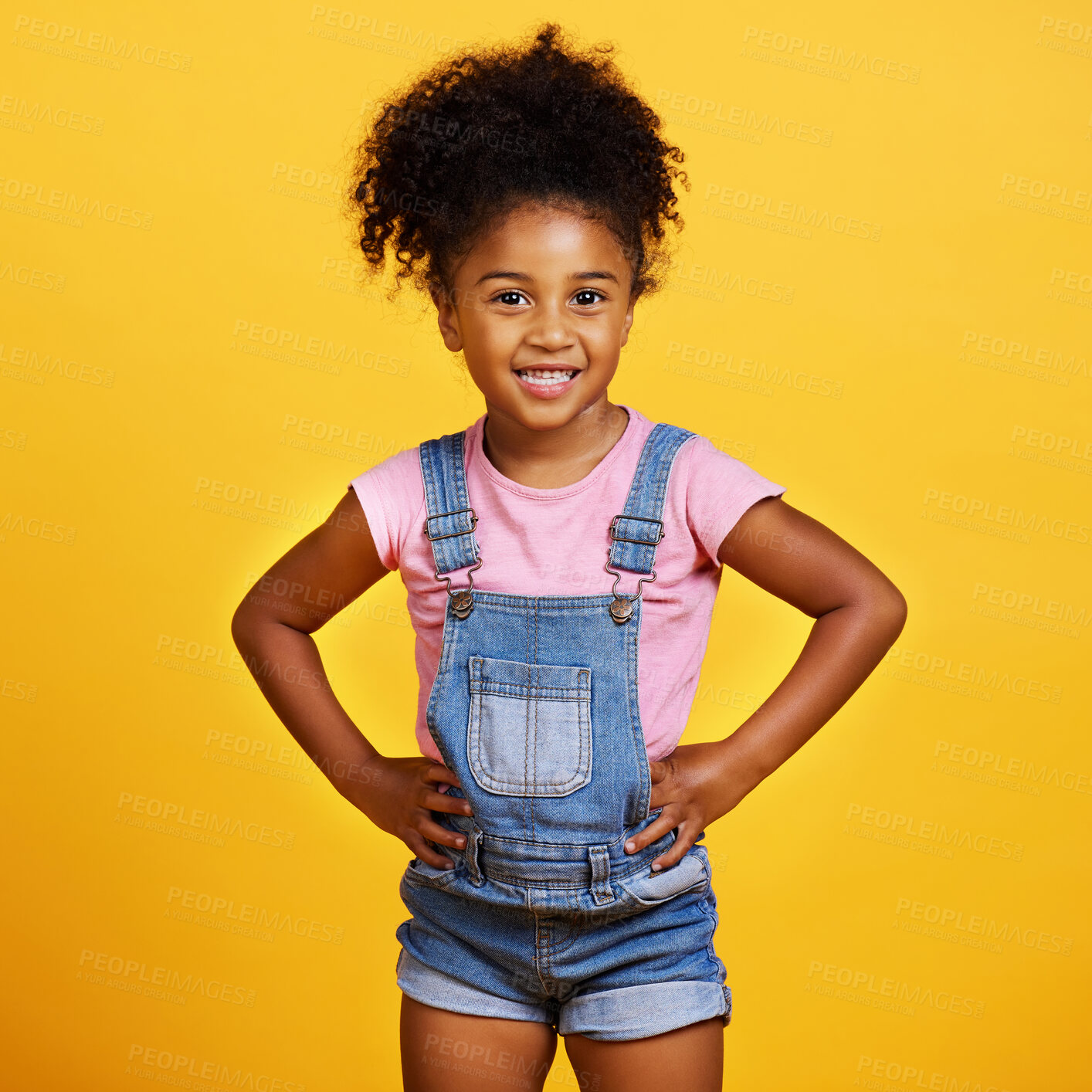 Buy stock photo Happy, portrait and child with a smile on face isolated on a yellow background. Cute young girl kid model with happiness, carefree and positive attitude in studio with hands on hips and mockup